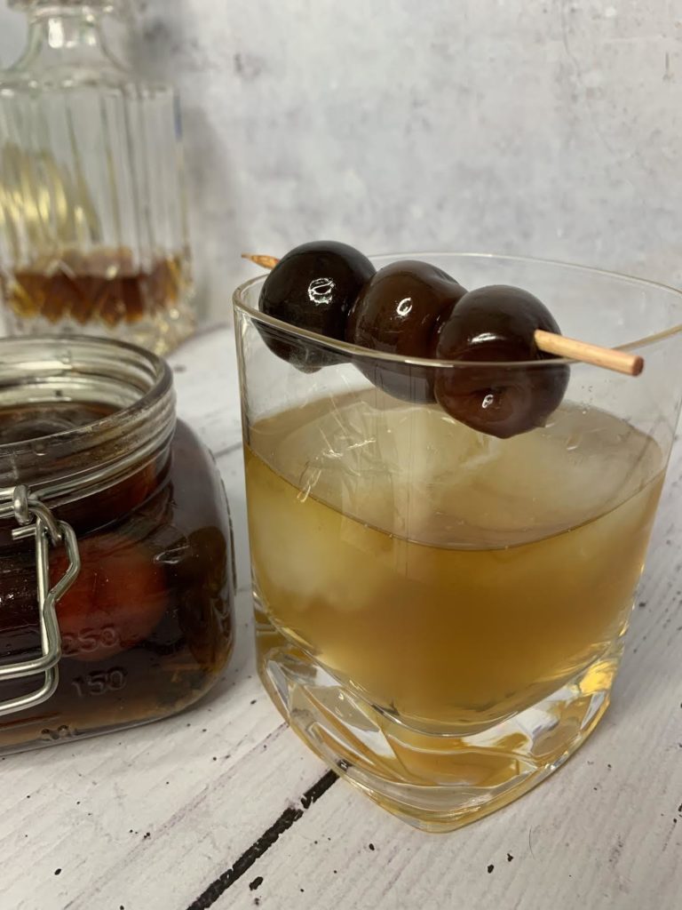 close up glass with cherry skewer