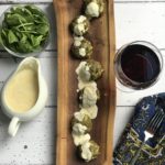 cover shot of sauce, meatballs and spinach